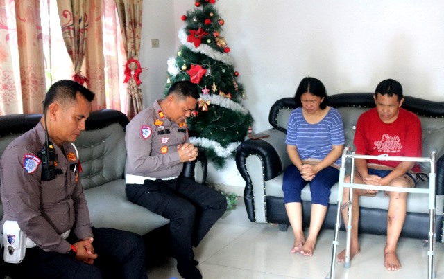 Kepala Satlantas Polres Nias, AKP Sonahami Lase mendoakan kesembuhan pasangan pendeta yang menjadi korban kecelakaan lalu lintas. ISTIMEWA/BALUSENIAS.COM