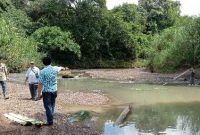 Kepala Desa Botona'ai, Sozanolo Gulo, bersama warganya mengukur lebar Sungai Na'ai di lokasi yang diharap akan dibangun sebuah jembatan. HASRAT HULU/BALUSENIAS.COM  