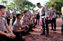 Kapolres Nias AKBP Revi Nurvelani mengguyur perwakilan personel yang menerima kenaikan pangkat sebagai tradisi di tubuh Polri. ISTIMEWA/BALUSENIAS.COM